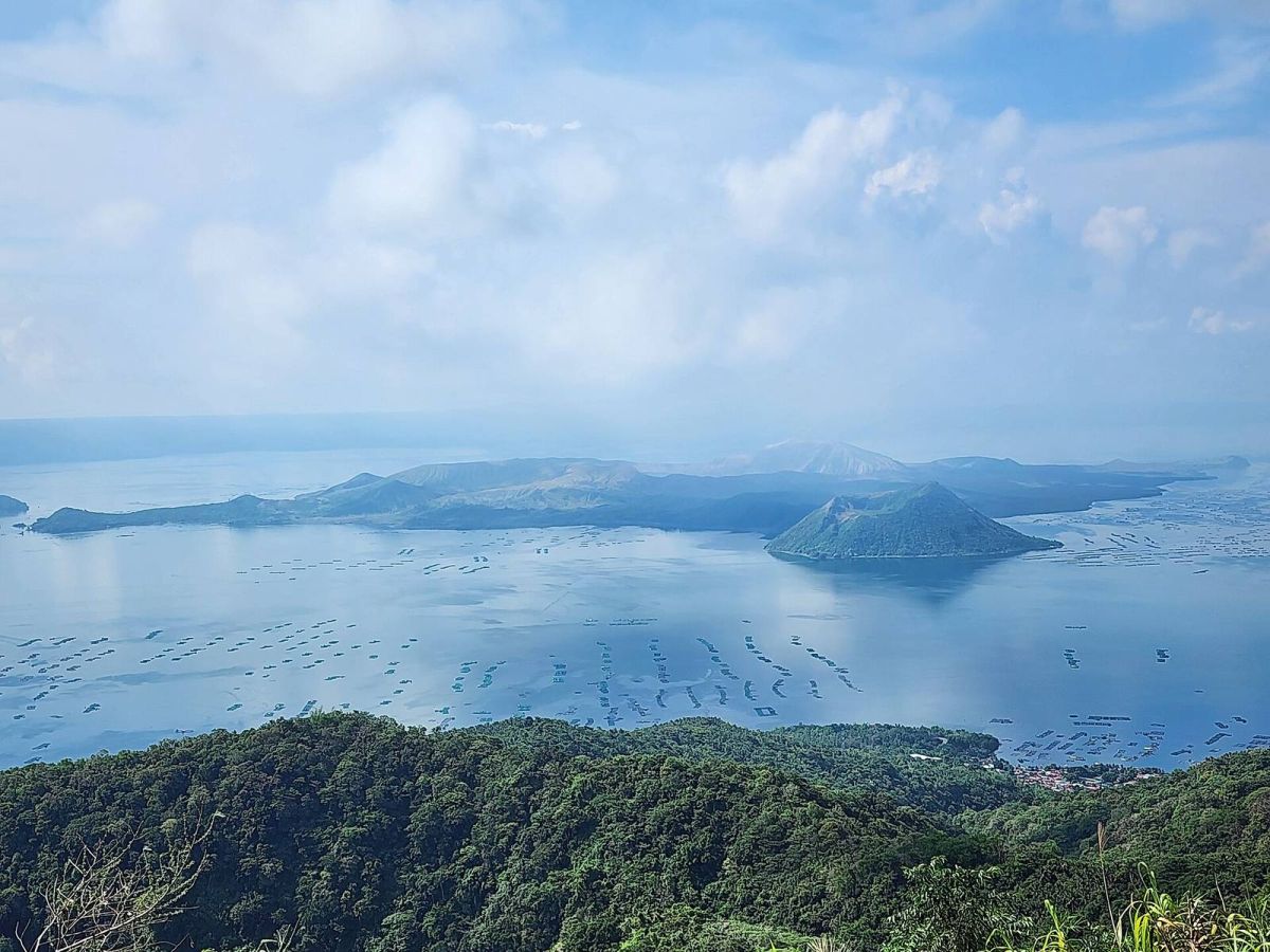 Taal Volcano island in Taal Lake viewed from the Tagaytay ridge, with fish pens on the water